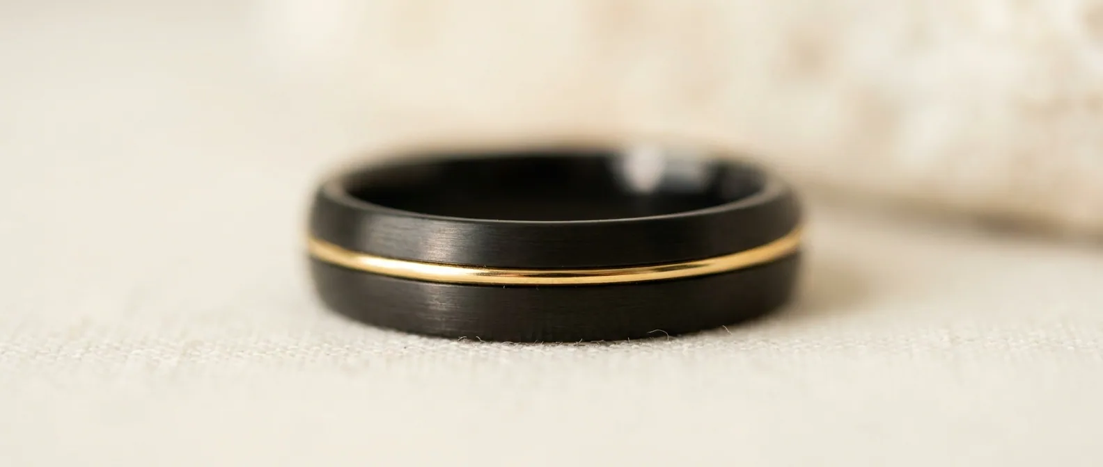 Macro of a gold line inlaid into a matte black band